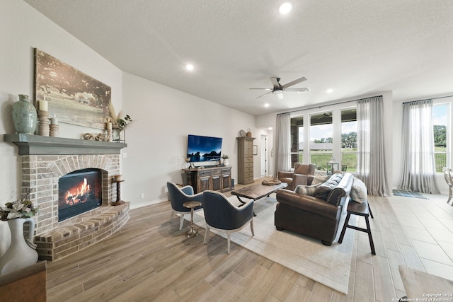 122 Indigo Bnd, Boerne, TX 78006 - living room featuring wood finished floors, ceiling fan, a fireplace, recessed lighting, and a textured ceiling