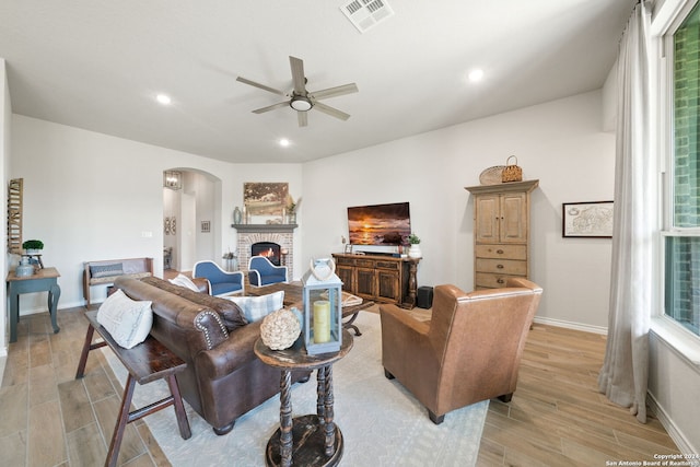 122 Indigo Bnd, Boerne, TX 78006 - living area with arched walkways, light wood-style flooring, ceiling fan, baseboards, and recessed lighting