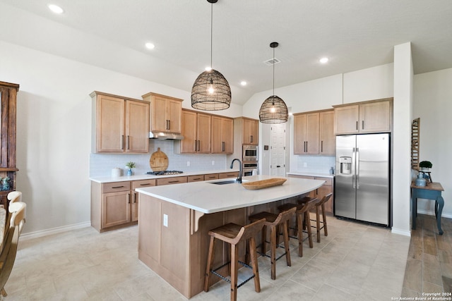 122 Indigo Bnd, Boerne, TX 78006 - kitchen with stainless steel appliances, a sink, decorative backsplash, a kitchen island with sink, and light countertops