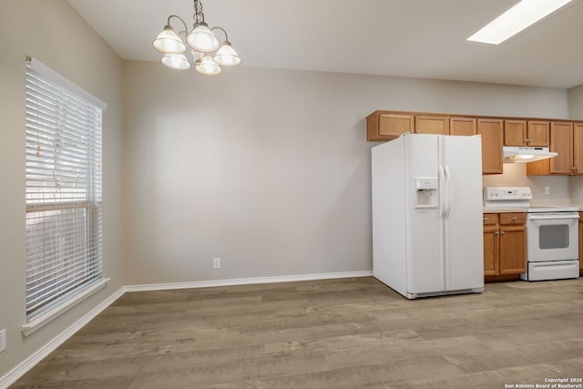 543 Willow Grove Dr, San Antonio, TX 78245 - kitchen with white appliances, under cabinet range hood, light wood-style flooring, a chandelier, and baseboards