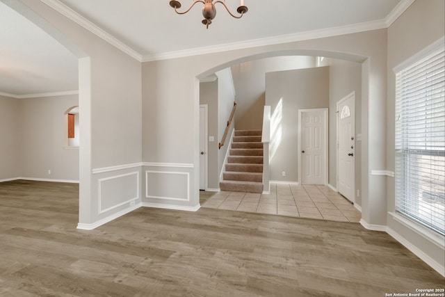 543 Willow Grove Dr, San Antonio, TX 78245 - entrance foyer with arched walkways, stairway, wood finished floors, ornamental molding, and a chandelier