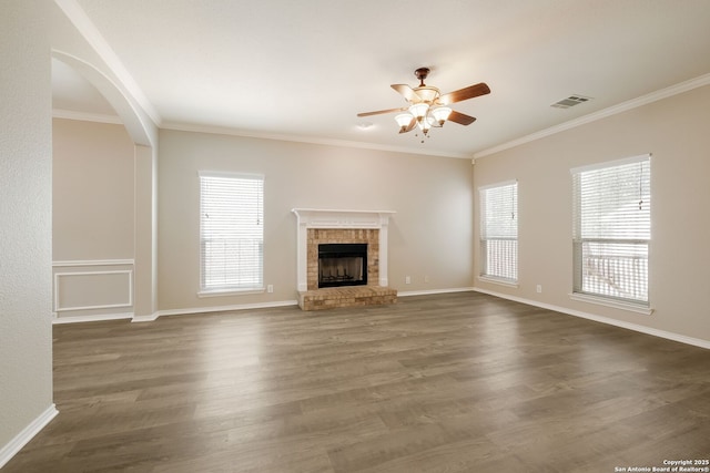 543 Willow Grove Dr, San Antonio, TX 78245 - unfurnished living room with ceiling fan, plenty of natural light, a fireplace, ornamental molding, and dark wood-type flooring