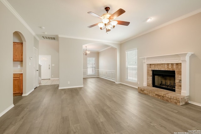 543 Willow Grove Dr, San Antonio, TX 78245 - unfurnished living room with a ceiling fan, crown molding, wood finished floors, a brick fireplace, and baseboards