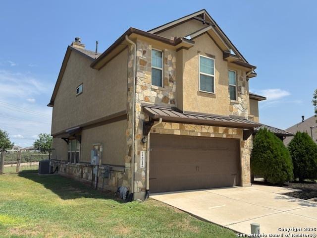 12012 Ivy Post, Schertz, TX 78154 - view of front of home featuring a garage, central air condition unit, concrete driveway, a standing seam roof, and stone siding