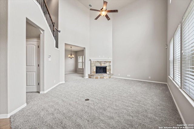 12012 Ivy Post, Schertz, TX 78154 - unfurnished living room featuring a high ceiling, carpet, ceiling fan, a stone fireplace, and baseboards