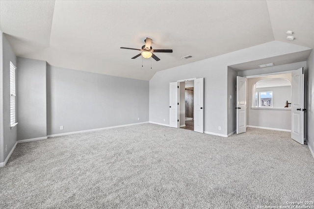 12012 Ivy Post, Schertz, TX 78154 - unfurnished bedroom featuring carpet, baseboards, arched walkways, vaulted ceiling, and a ceiling fan