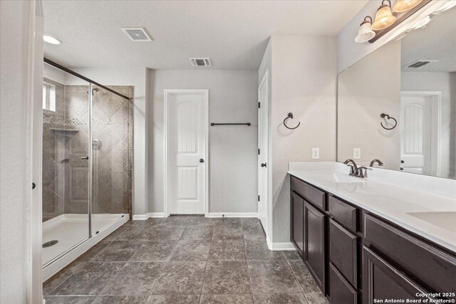 12012 Ivy Post, Schertz, TX 78154 - bathroom featuring a stall shower, double vanity, and baseboards