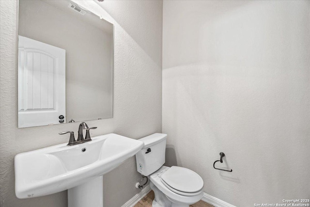 12012 Ivy Post, Schertz, TX 78154 - bathroom featuring a sink, toilet, and baseboards