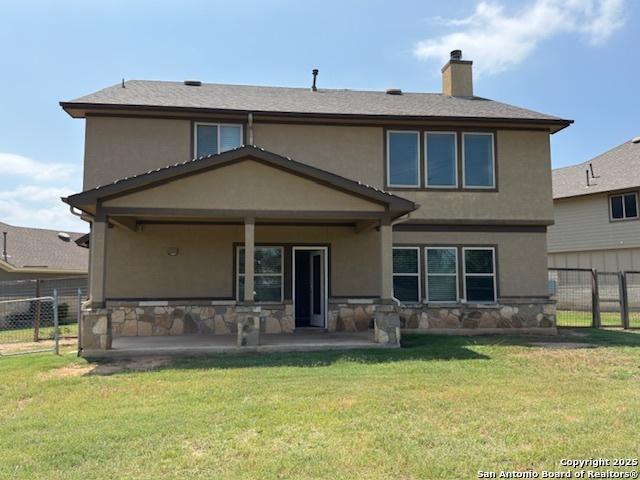 12012 Ivy Post, Schertz, TX 78154 - back of house with stucco siding, stone siding, a chimney, and a patio
