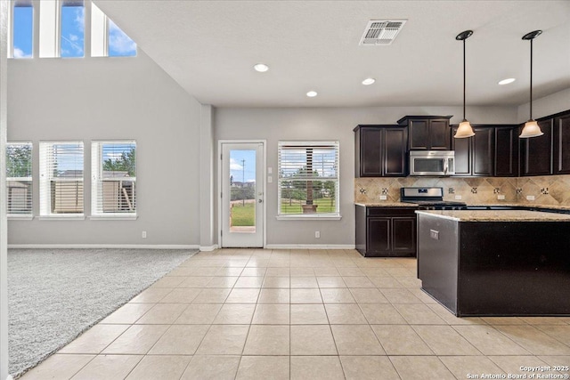 12012 Ivy Post, Schertz, TX 78154 - kitchen with stainless steel appliances, baseboards, light colored carpet, light tile patterned flooring, and tasteful backsplash