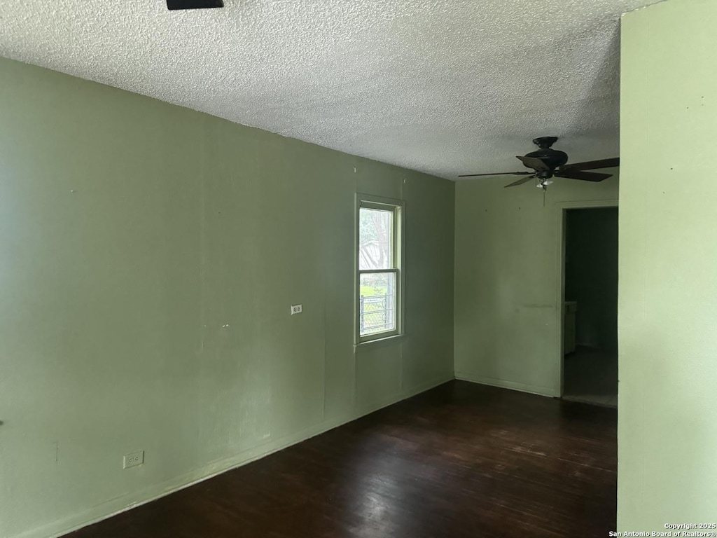 907 Recio, San Antonio, TX 78225 - empty room with a textured ceiling, dark wood-style floors, ceiling fan, and baseboards