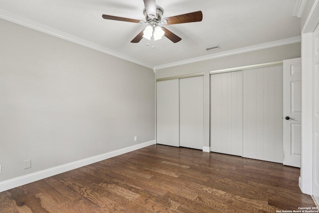 12102 Cherry Blossom, San Antonio, TX 78247 - unfurnished bedroom featuring multiple closets, ornamental molding, wood finished floors, baseboards, and a ceiling fan