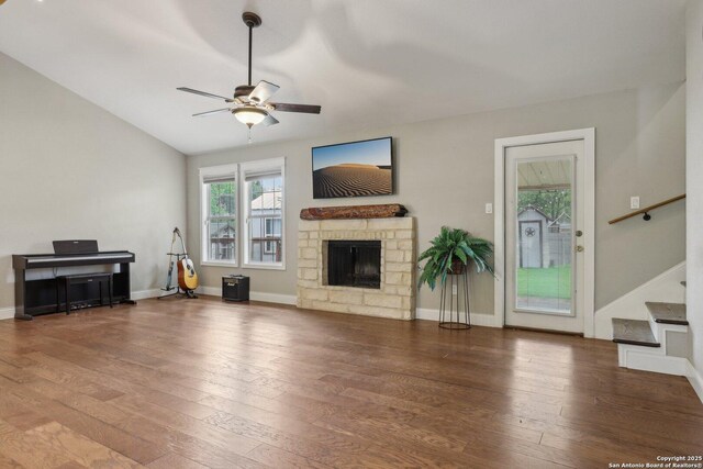 12102 Cherry Blossom, San Antonio, TX 78247 - unfurnished living room featuring ceiling fan, a fireplace, hardwood / wood-style flooring, stairs, and baseboards