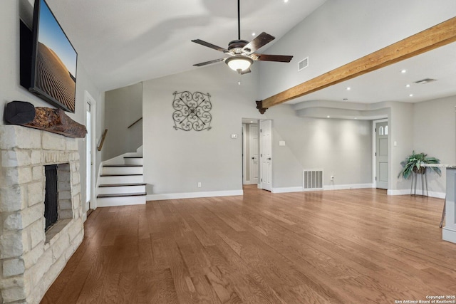 12102 Cherry Blossom, San Antonio, TX 78247 - unfurnished living room with a ceiling fan, wood finished floors, a stone fireplace, stairs, and recessed lighting