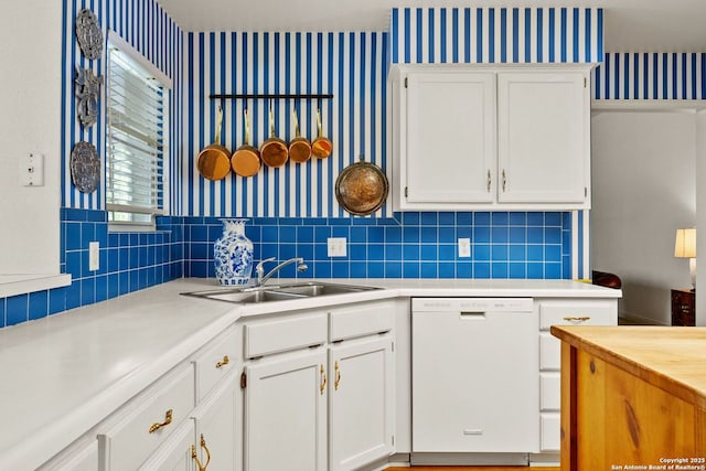 557 Timber Holw, New Braunfels, TX 78132 - kitchen featuring dishwasher, a sink, light countertops, wallpapered walls, and white cabinetry