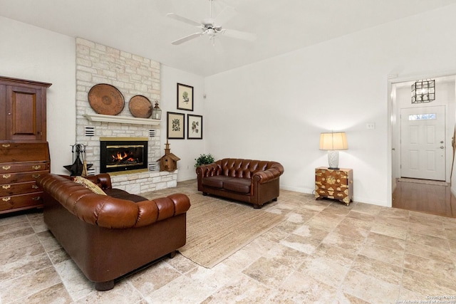 557 Timber Holw, New Braunfels, TX 78132 - living room featuring a ceiling fan, a stone fireplace, and light stone finish flooring