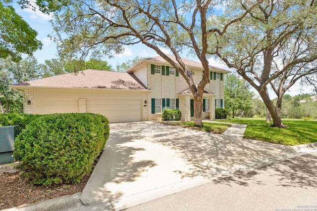 557 Timber Holw, New Braunfels, TX 78132 - colonial house with an attached garage, driveway, brick siding, and a front yard