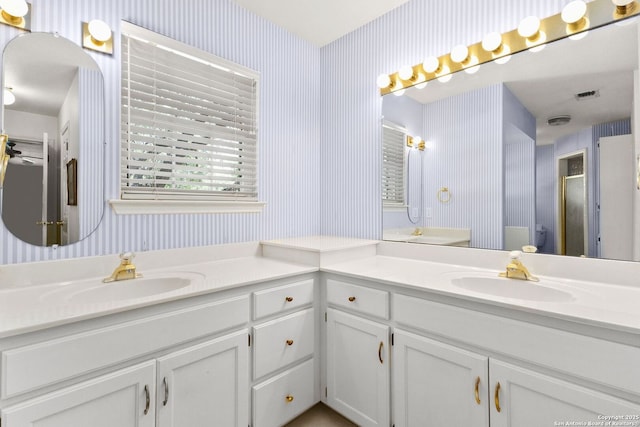 557 Timber Holw, New Braunfels, TX 78132 - full bathroom featuring wallpapered walls, double vanity, and a stall shower