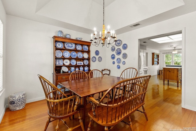 557 Timber Holw, New Braunfels, TX 78132 - dining area with a chandelier, light wood finished floors, baseboards, and a ceiling fan