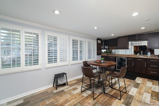 311 Redcliff, San Antonio, TX 78216 - kitchen with beverage cooler, a sink, ornamental molding, baseboards, and dark brown cabinetry