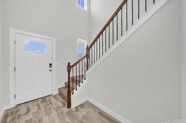 771 Fort Leonard, San Antonio, TX 78245 - foyer featuring healthy amount of natural light, baseboards, a towering ceiling, stairs, and light wood finished floors