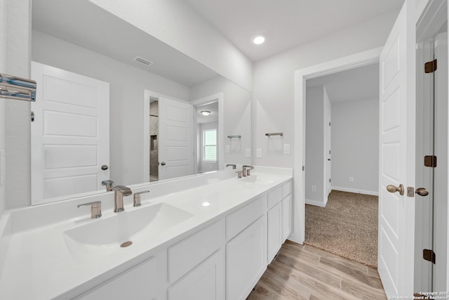 771 Fort Leonard, San Antonio, TX 78245 - bathroom with double vanity, wood finished floors, baseboards, and recessed lighting