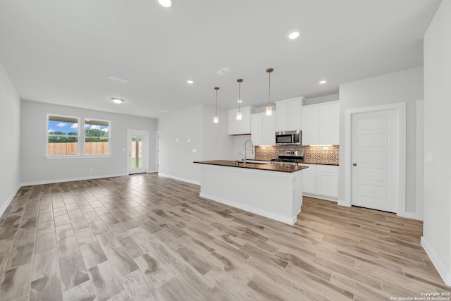771 Fort Leonard, San Antonio, TX 78245 - kitchen with stainless steel appliances, dark countertops, open floor plan, decorative backsplash, and recessed lighting