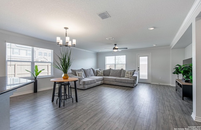 14755 Grey Egret Run, San Antonio, TX 78253 - living area featuring a chandelier, a ceiling fan, dark wood-style flooring, baseboards, and ornamental molding