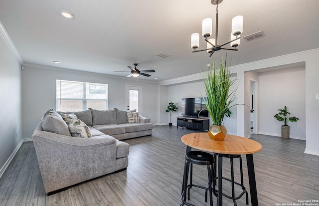 14755 Grey Egret Run, San Antonio, TX 78253 - living room featuring ceiling fan, baseboards, ornamental molding, wood finished floors, and a chandelier