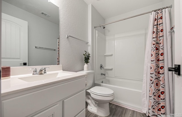 14755 Grey Egret Run, San Antonio, TX 78253 - bathroom with vanity, toilet, wood finished floors, shower / bathtub combination with curtain, and a textured wall
