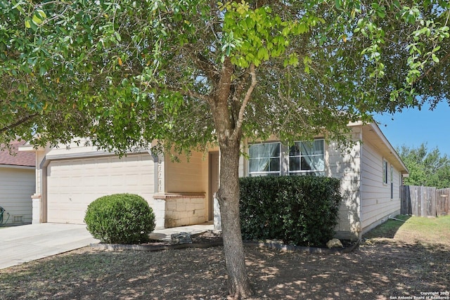 25703 Lost Creek Way, Boerne, TX 78015 - view of property hidden behind natural elements featuring a garage and concrete driveway