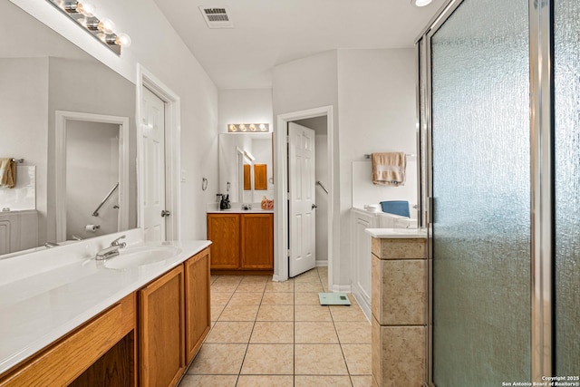 22207 Impala Peak, San Antonio, TX 78259 - bathroom with two vanities, a stall shower, and tile patterned floors