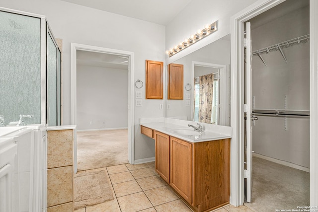 22207 Impala Peak, San Antonio, TX 78259 - full bath featuring vanity, a walk in closet, a stall shower, and baseboards