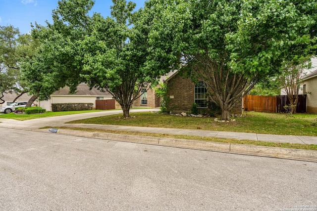 22207 Impala Peak, San Antonio, TX 78259 - view of property hidden behind natural elements featuring driveway and brick siding