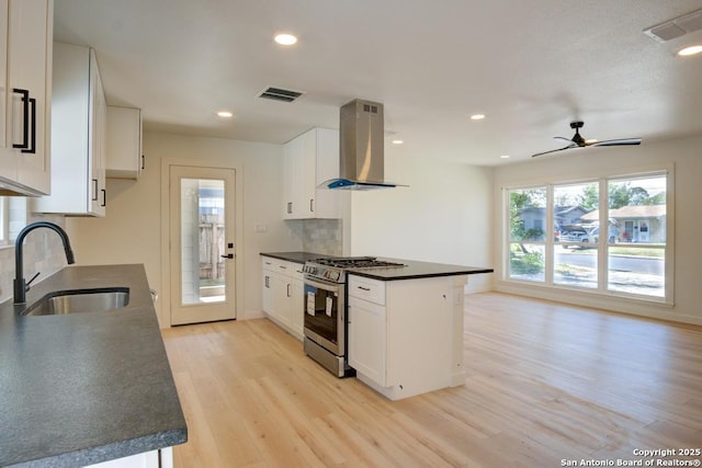 1514 Arroya Vis, San Antonio, TX 78213 - kitchen with extractor fan, gas range, dark countertops, a sink, and recessed lighting
