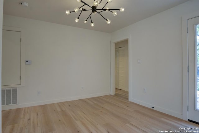 1514 Arroya Vis, San Antonio, TX 78213 - spare room featuring light wood-style floors, a chandelier, baseboards, and a smoke detector