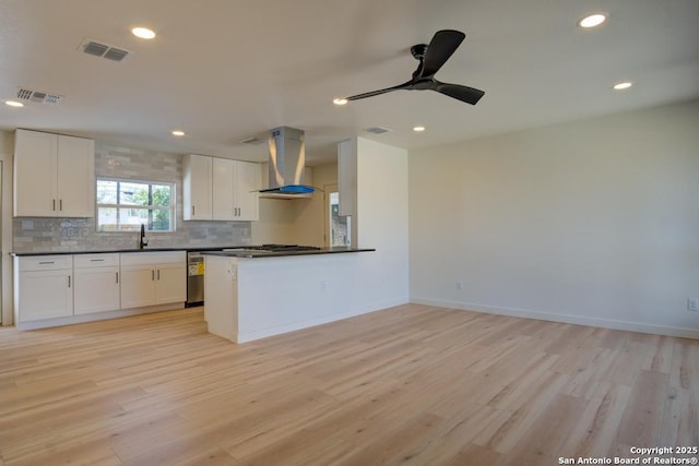 1514 Arroya Vis, San Antonio, TX 78213 - kitchen with range hood, dark countertops, light wood finished floors, tasteful backsplash, and recessed lighting