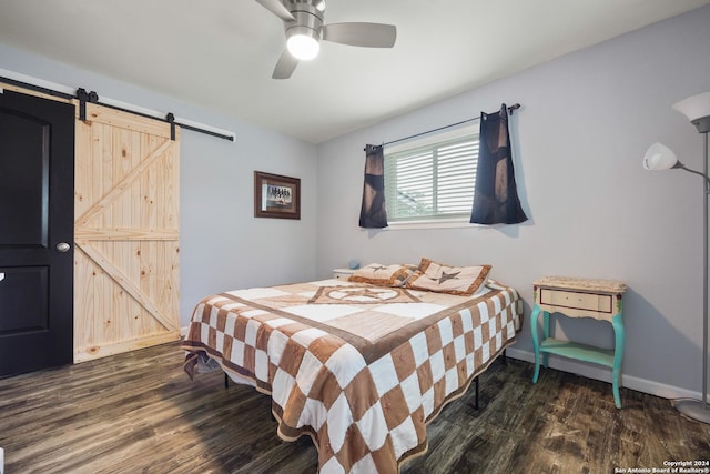 1215 Amanda, Canyon Lake, TX 78133 - bedroom with a barn door, dark wood-style flooring, ceiling fan, and baseboards