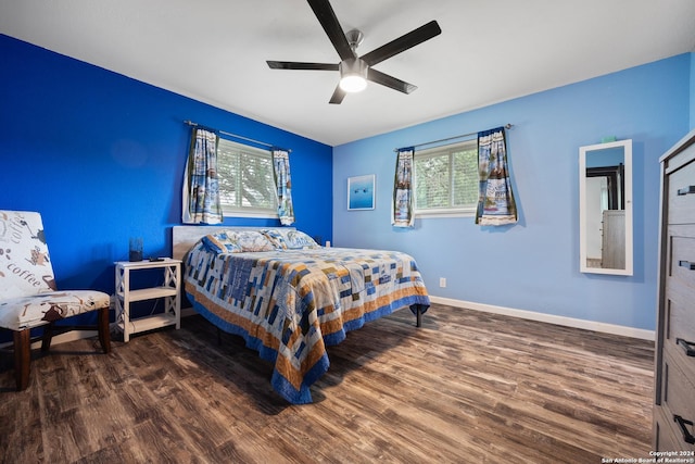 1215 Amanda, Canyon Lake, TX 78133 - bedroom featuring multiple windows, wood finished floors, and baseboards