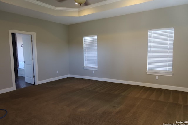 178 Spring Creek Cir, Bandera, TX 78003 - spare room featuring dark colored carpet, crown molding, a raised ceiling, baseboards, and ceiling fan