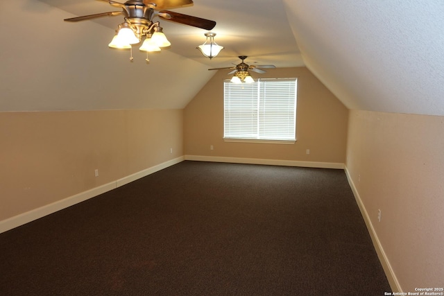 178 Spring Creek Cir, Bandera, TX 78003 - additional living space with a ceiling fan, baseboards, vaulted ceiling, and dark carpet