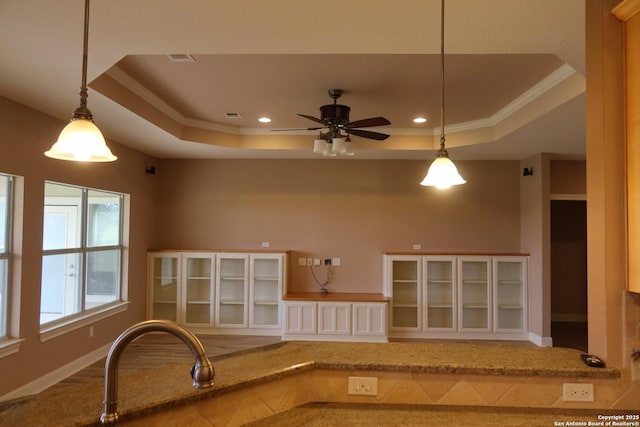 178 Spring Creek Cir, Bandera, TX 78003 - kitchen featuring a raised ceiling, ceiling fan, recessed lighting, ornamental molding, and white cabinets