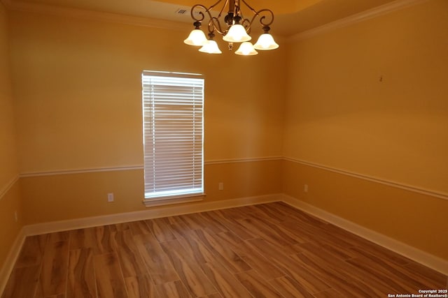 178 Spring Creek Cir, Bandera, TX 78003 - spare room featuring ornamental molding, wood finished floors, a chandelier, and baseboards