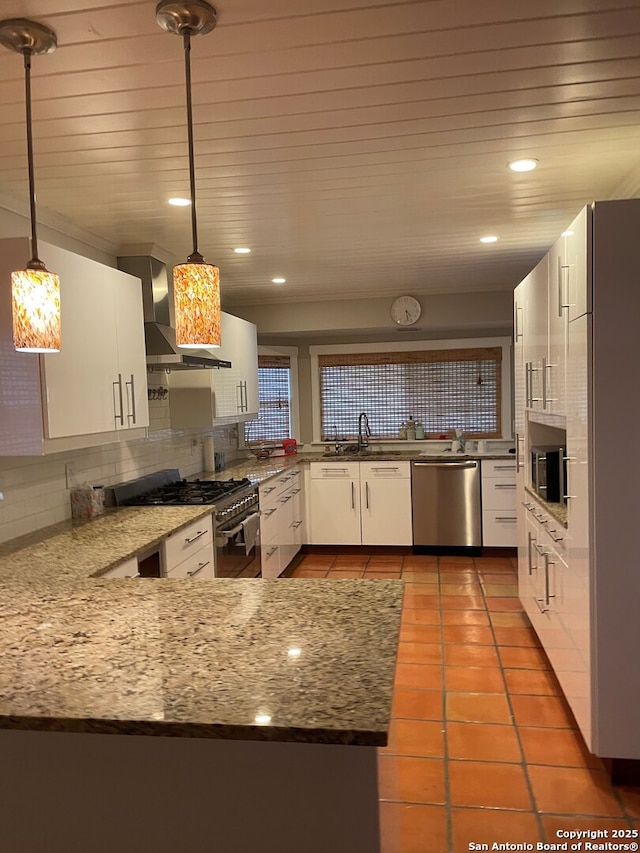 14102 Anabella, San Antonio, TX 78247 - kitchen with appliances with stainless steel finishes, tasteful backsplash, wall chimney range hood, white cabinetry, and recessed lighting