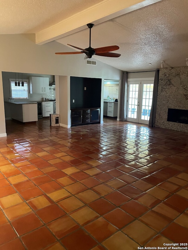 14102 Anabella, San Antonio, TX 78247 - unfurnished living room with tile patterned flooring, a ceiling fan, a textured ceiling, baseboards, and a large fireplace