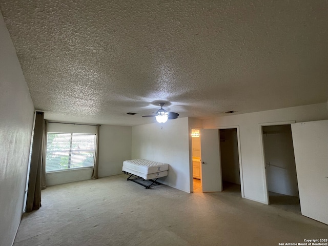 14102 Anabella, San Antonio, TX 78247 - bedroom with a textured ceiling, multiple closets, light colored carpet, ceiling fan, and connected bathroom