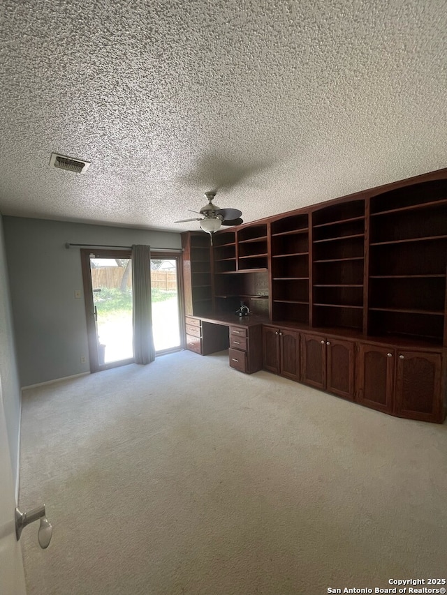 14102 Anabella, San Antonio, TX 78247 - unfurnished living room with a textured ceiling, carpet flooring, and ceiling fan
