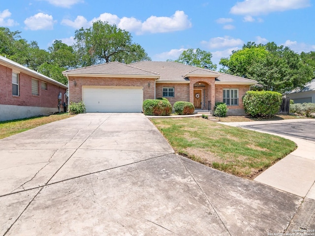 6 Oakwell Farms, San Antonio, TX 78218 - ranch-style house with a tile roof, driveway, an attached garage, brick siding, and a front yard