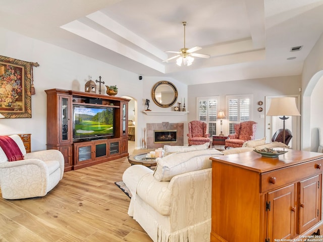 6 Oakwell Farms, San Antonio, TX 78218 - living area with a tray ceiling, a ceiling fan, a high end fireplace, and light wood finished floors