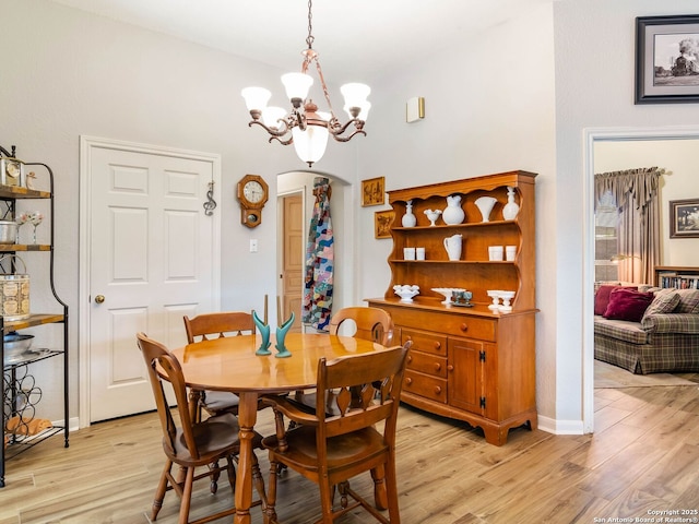 6 Oakwell Farms, San Antonio, TX 78218 - dining room featuring a chandelier, arched walkways, light wood finished floors, and baseboards